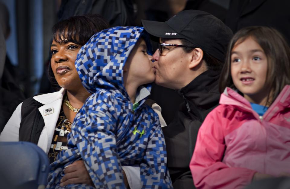 Karen Joseph kisses her son Thunder while he sat with Bernice King, daughter of Martin Luther King Jr while attending a First Nations' Truth and Reconciliation gathering and march in Vancouver, British Columbia September 22, 2013. First Nations people, many survivors of the abuse at former Canadian Government Indian Residential Schools, have been meeting for the past week. REUTERS/Andy Clark (CANADA - Tags: SOCIETY)