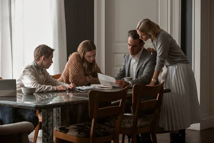 Children, played by Luke David Blumm as Carter and Isabel Gravitt as Ellie, with Bobby Cannavale and Naomi Watts as the couple, sitting or standing around a table