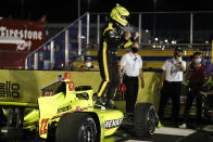 Simon Pagenaud, of France, celebrates in Victory Lane after winning an IndyCar Series auto race Friday, July 17, 2020, at Iowa Speedway in Newton, Iowa. (AP Photo/Charlie Neibergall)