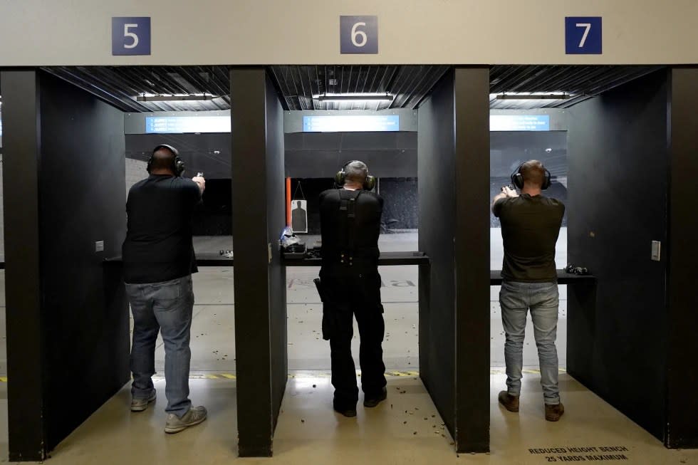 Gun owners fire their pistols at an indoor shooting range during a qualification course to renew their carry concealed handgun permits, July 1, 2022, at the Placer Sporting Club in Roseville, Calif. (AP Photo/Rich Pedroncelli, File)