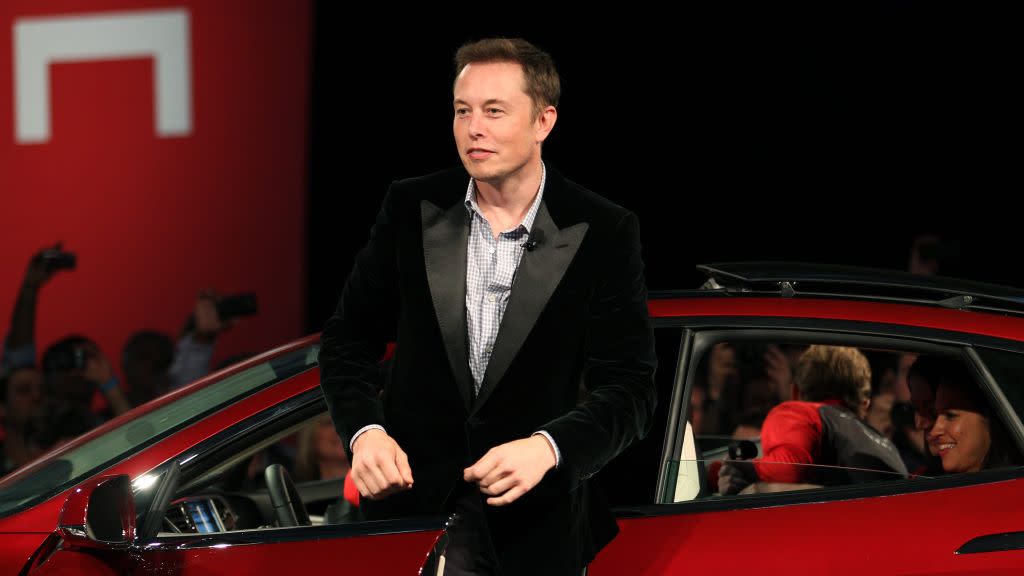 Tesla Motors CEO Elon Musk alights from a Model S sedan at the Tesla factory in Fremont