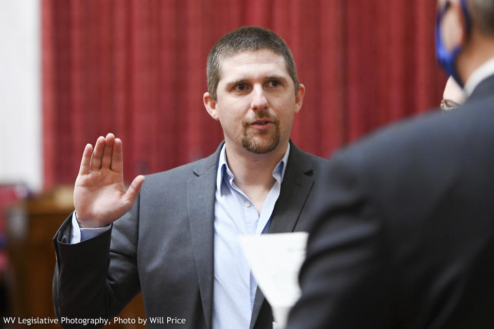 FILE - In this image provided by the West Virginia Legislative Photography, Derrick Evans raises his hand during a swearing-in ceremony to the West Virginia House of Delegates on Dec. 1, 2020, in Charleston, W.Va. Evans was sentenced to three months in prison for his participation in the Jan. 6, 2021, riot at the U.S. Capitol. Evans will face U.S. Rep. Carol Miller in the West Virginia 1st Congressional District Republican primary on Tuesday, May 14, 2024. (Will Price/West Virginia Legislative Photography via AP, File)