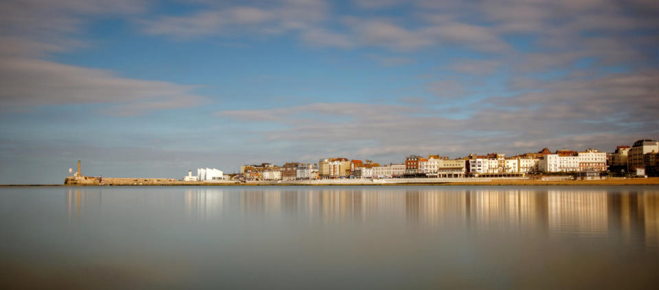 Seaside town beach water reflections of Margate harbour.