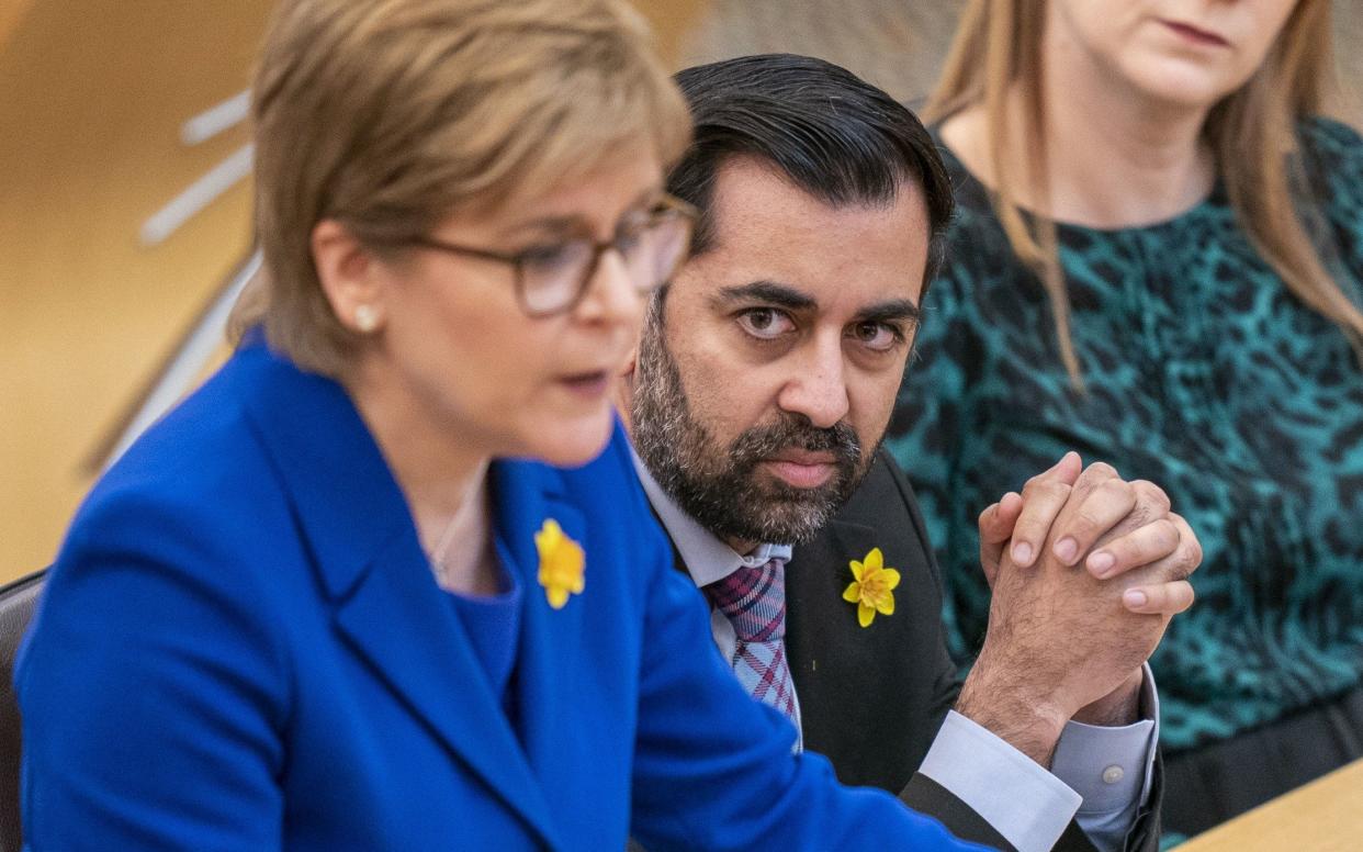 Humza Yousaf watching Nicola Sturgeon speak in the Scottish Parliament, Holyrood