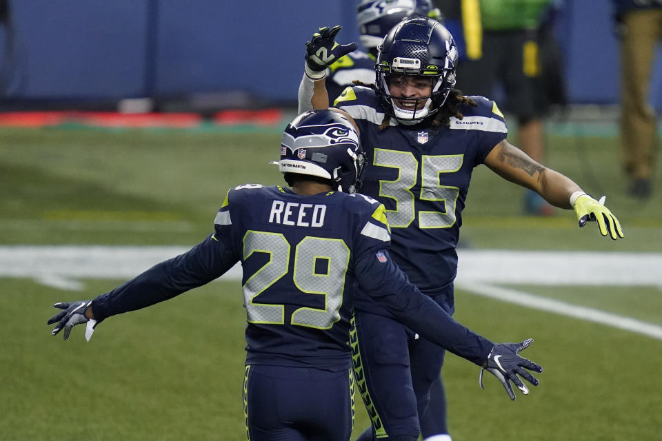 Seattle Seahawks strong safety Ryan Neal (35) and Seattle Seahawks free safety D.J. Reed (29) celebrate a play during the second half of an NFL football game against the Los Angeles Rams, Sunday, Dec. 27, 2020, in Seattle. The Seahawks won 20-9. (AP Photo/Elaine Thompson)