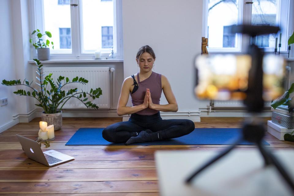 Marlene of Yoga on the Move Berlin warms up prior to conducting an online session in her home on March 25, 2020 in Berlin, Germany: Maja Hitij/Getty Images