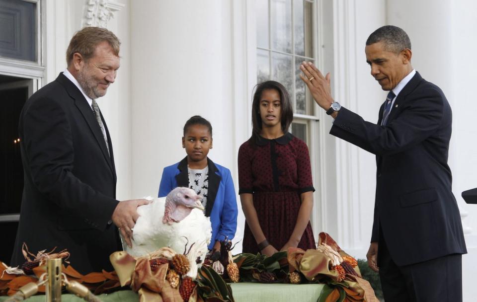 President Barack Obama, with daughters Sasha and Malia, pardons “Liberty,” a 19-week old, 45-pound turkey, on the occasion of Thanksgiving, Wednesday, Nov. 23, 2011, on the North Portico of the White House in Washington. At left is National Turkey Federation Chairman Richard Huisinga. (Photo: Pablo Martinez Monsivais/AP)