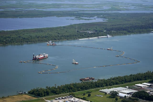 <p>Gerald Herbert/AP Photo</p> This Sept. 26 news photo shows dredging operations to build an underwater sill in Plaquemines Parish, La.