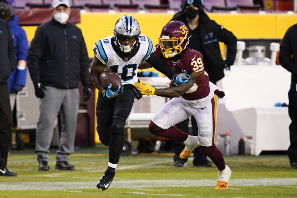 Carolina Panthers wide receiver Curtis Samuel (10) runs with the ball as he is chased by Washington Football Team defensive back Jeremy Reaves (39) during the first half of an NFL football game, Sunday, Dec. 27, 2020, in Landover, Md. (AP Photo/Susan Walsh)