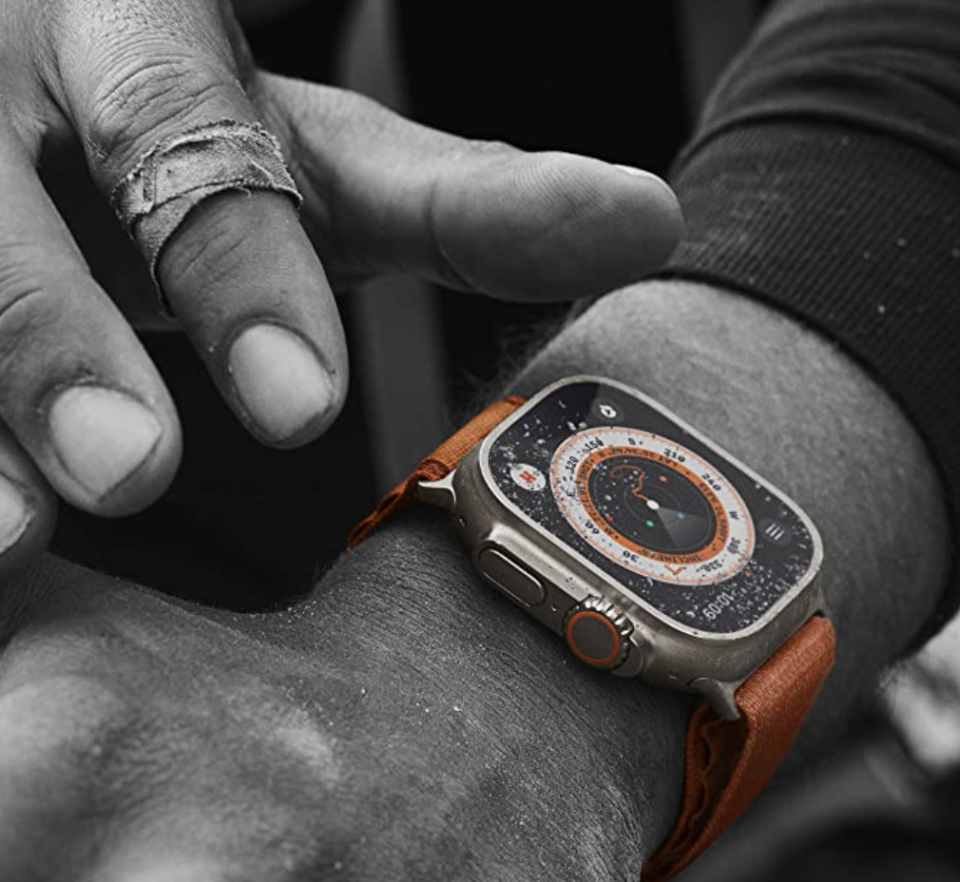 Apple Watch Ultra (GPS + Cellular, 49mm) Smartwatch with orange strap.