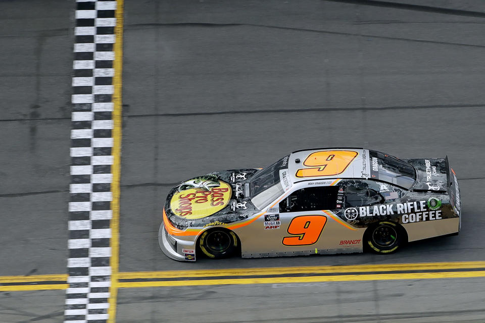 Noah Gragson (9) prepares to cross the finish line to win the NASCAR Xfinity series auto race Saturday, Feb. 15, 2020, at Daytona International Speedway in Daytona Beach, Fla. (AP Photo/Chris O'Meara)