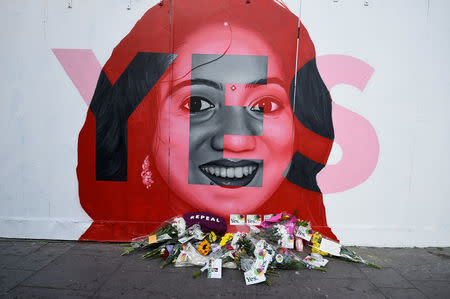 Flowers are left at the foot of a new mural of Savita Halappanavar put up on the day of the Abortion Referendum on liberalising abortion laws in Dublin, Ireland May 25, 2018. REUTERS/Clodagh Kilcoyne