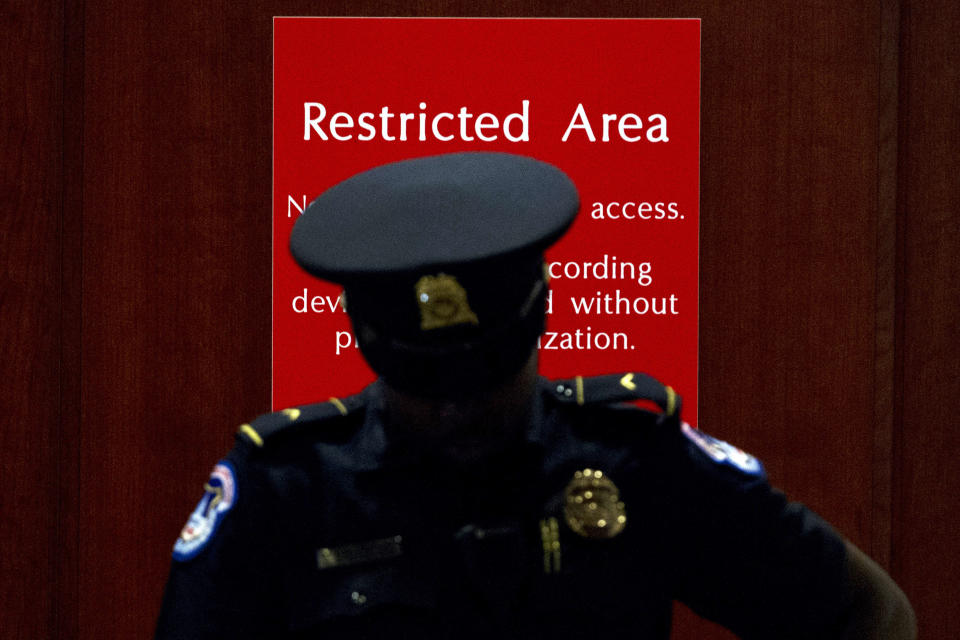 A U.S. Capitol Police officer stands at the entrance to a secure area during closed-door interviews with Kurt Volker, a former special envoy to Ukraine, as House Democrats proceed with the impeachment investigation of President Donald Trump, at the Capitol in Washington, Thursday, Oct. 3, 2019. (AP Photo/Jose Luis Magana)