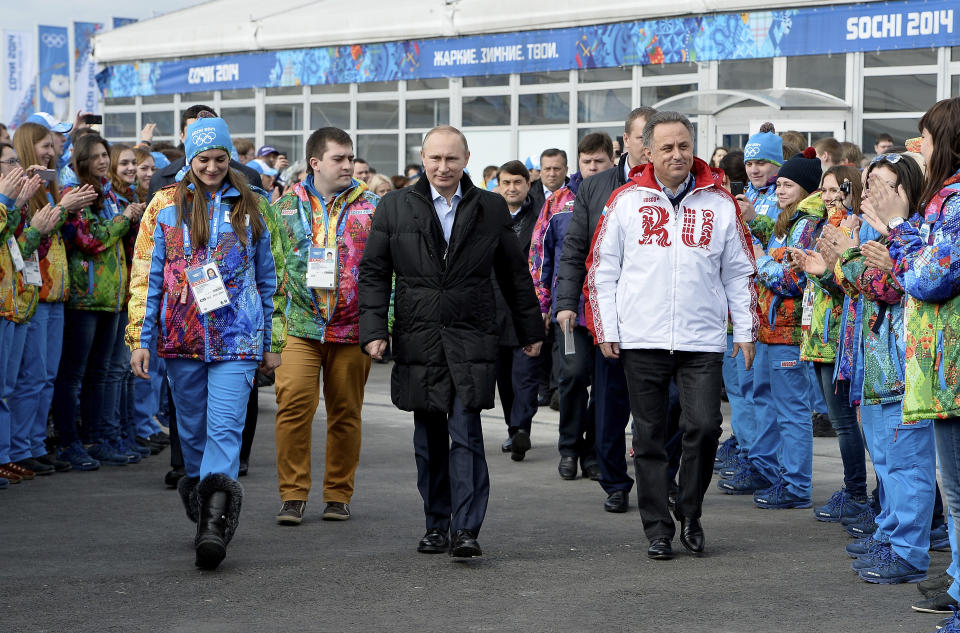 FILE - In this Wednesday, Feb. 5, 2014 file photo, Russian President Vladimir Putin, center, visits the Olympic Athletes Village in Coastal Cluster ahead of the Sochi 2014 Winter Olympics with Olympic Village Mayor Elena Isinbaeva, left, and Russian Minister of Sport, Tourism and Youth policy Vitaly Mutko in Sochi, Russia. Japanese Prime Minister Shinzo Abe and his Chinese counterpart appear not to be bothered by the international ruckus over Russia's law restricting gay rights. Unlike President Barack Obama, who pointedly declined to attend the Winter Olympics, the leaders of the world's second and third largest economies — where gay rights are not a hot-button political issue — are going to Sochi. (AP Photo/Pascal Le Segretain, Pool, File)