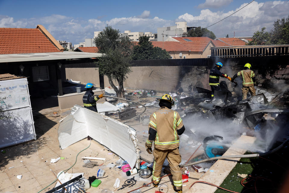 Israeli firefighters work to put out a fire at a private home after it was hit by a rocket launched from the Gaza Strip into Israel, in Sderot, southern Israel October 15, 2023. REUTERS/Amir Cohen