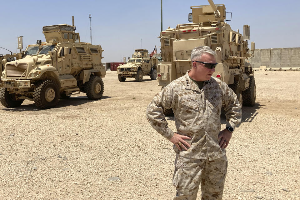 Marine Gen. Frank McKenzie, the top U.S. commander for the Middle East, speaks to the media after arriving in Syria to meet with U.S. and allied commanders and troops, Friday, May 21, 2021. The Iraqi government for the first time is expected to bring home about 100 Iraqi families from a sprawling camp in Syria next week, a move that U.S. officials see as a hopeful sign in the long-frustrated effort to repatriate thousands from the camp, known as a breeding ground for young insurgents. On an unannounced visit to Syria, McKenzie expressed optimism that the transfer from the al-Hol camp will happen. (AP Photo/Lolita C. Baldor)