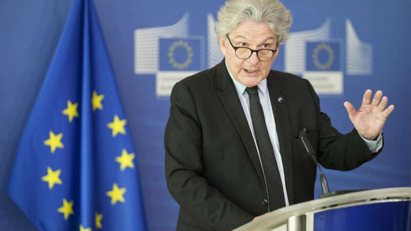 European Commissioner for the Internal Market Thierry Breton, speaking in front of a European Union flag.