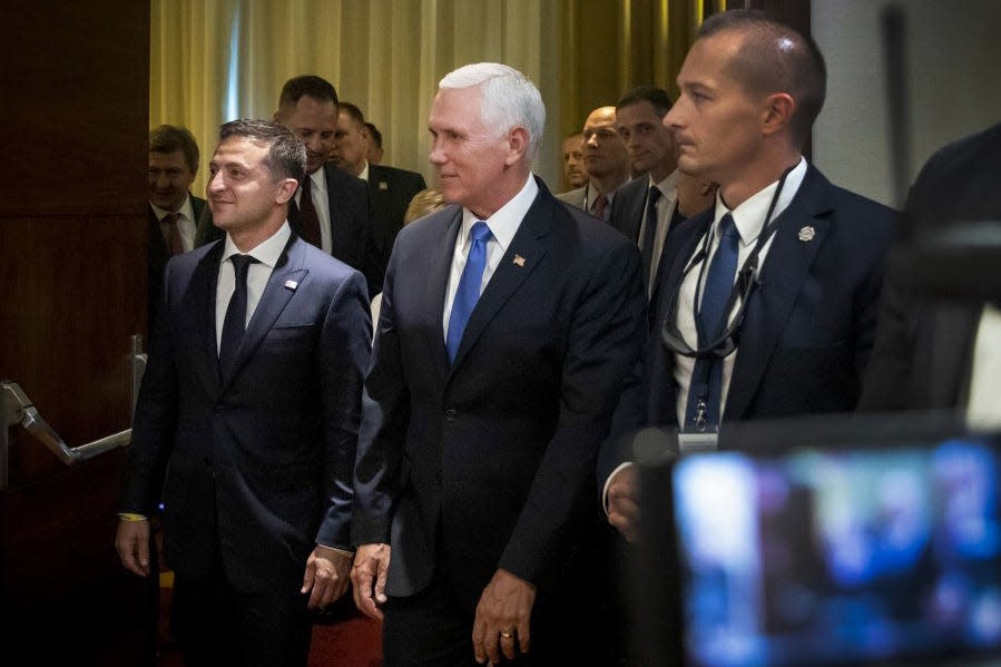 This handout picture taken and released by the Ukrainian presidential press-service on September 1, 2019, shows US Vice-President Mike Pence (C) and Ukrainian President Volodymyr Zelensky (L) walking prior to their talks in Warsaw.