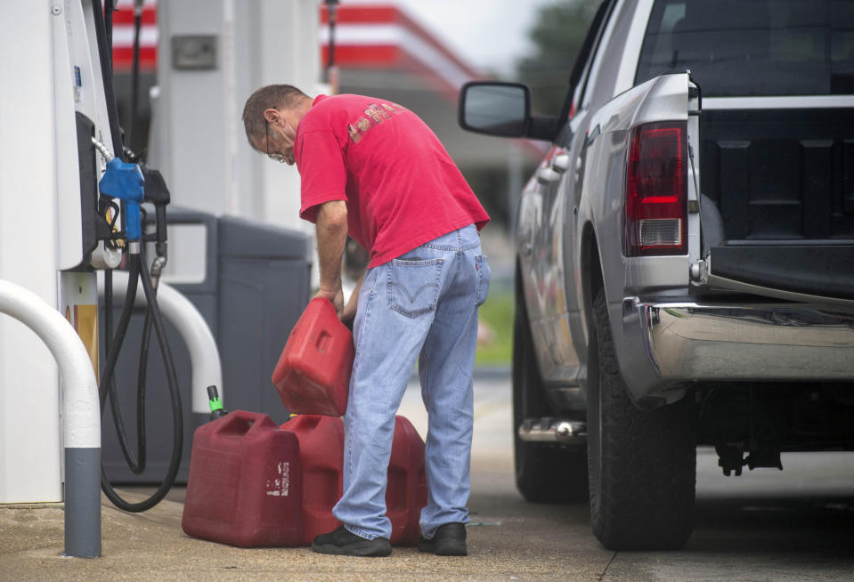 St. Bernard Parish residents fill up their cars and gas cans as the Louisiana coast prepares for the arrival of Hurricane Ida on Friday, Aug. 27, 2021 in New Orleans. Hurricane Ida struck Cuba on Friday and threatened to slam into Louisiana with devastating force over the weekend, prompting New Orleans’ mayor to order everyone outside the protection of the city’s levees to evacuate.(Chris Granger/The Times-Picayune/The New Orleans Advocate via AP)