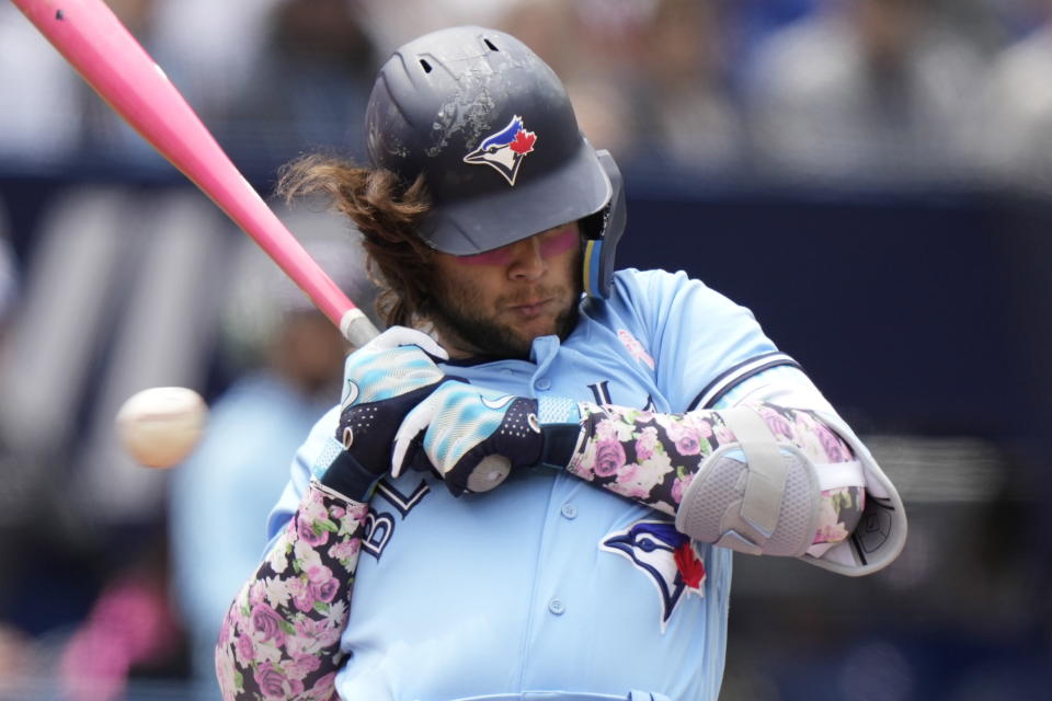 Toronto Blue Jays' Bo Bichette gets out of the way of an inside pitch during the second inning of a baseball game against the Atlanta Braves in Toronto, on Sunday, May 14, 2023. (Frank Gunn/The Canadian Press via AP)