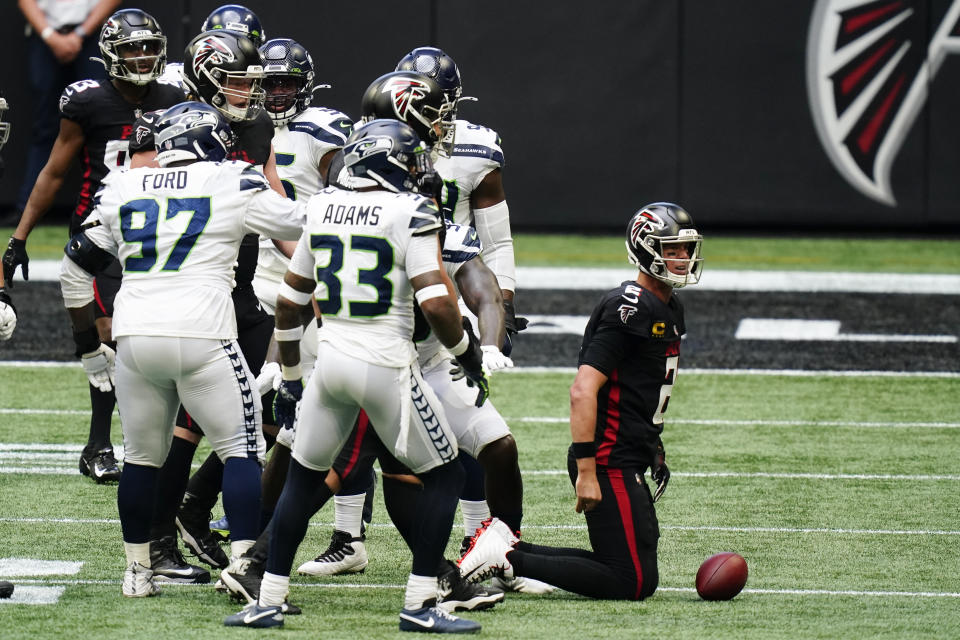 Atlanta Falcons quarterback Matt Ryan (2) gets up after being sacked by the Seattle Seahawks defense during the second half of an NFL football game, Sunday, Sept. 13, 2020, in Atlanta. (AP Photo/Brynn Anderson)