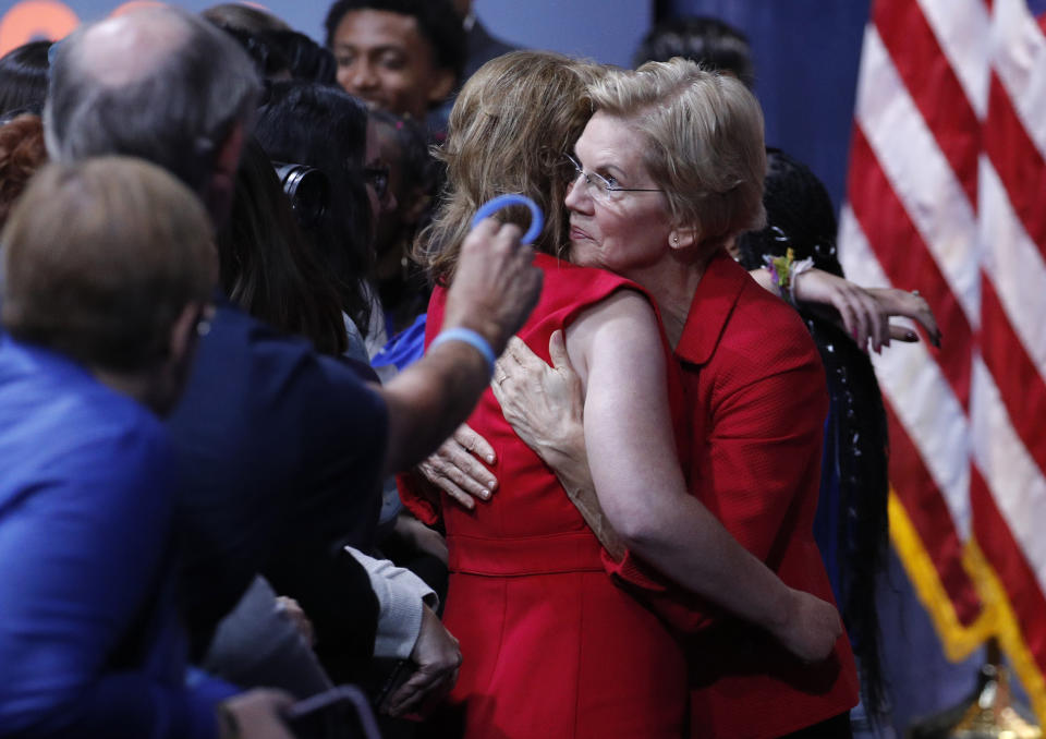 Democratic presidential candidate Sen. Elizabeth Warren, D-Mass., right, hugs former Rep. Gabby Giffords during a gun safety forum Wednesday, Oct. 2, 2019, in Las Vegas. (AP Photo/John Locher)