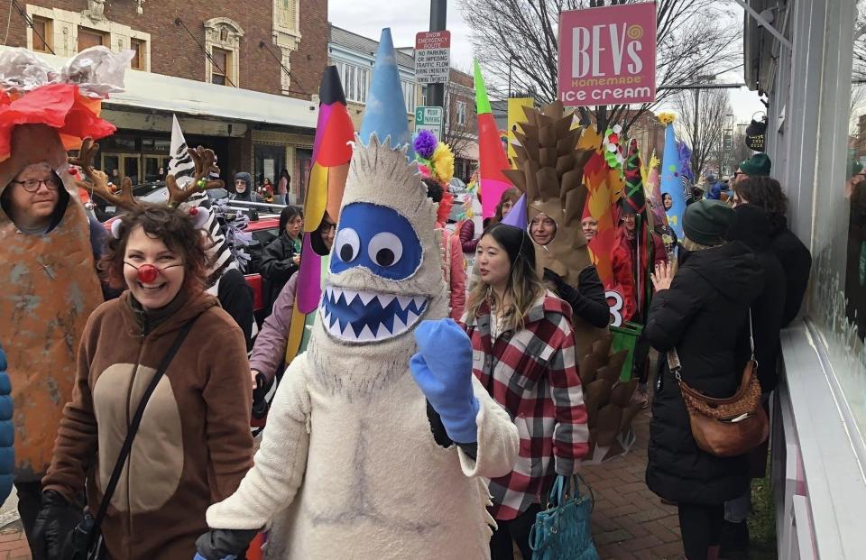 The Carytown Cone Parade procession in Richmond on January 1, 2024. Vanessa North won first place for her Abominable Snow-Cone costume. She enlisted her friend Debra Rice to portray Rudolph as her living accessory.