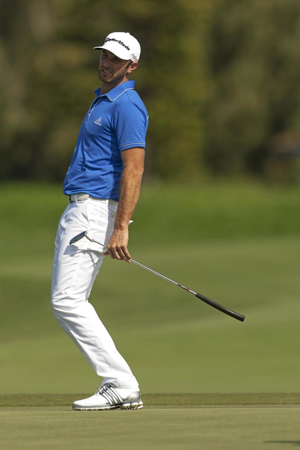 Dustin Johnson watches his putt on the second green during the third round of the Tournament of Champions golf tournament, Sunday, Jan. 5, 2014, in Kapalua, Hawaii. (AP Photo/Marco Garcia)