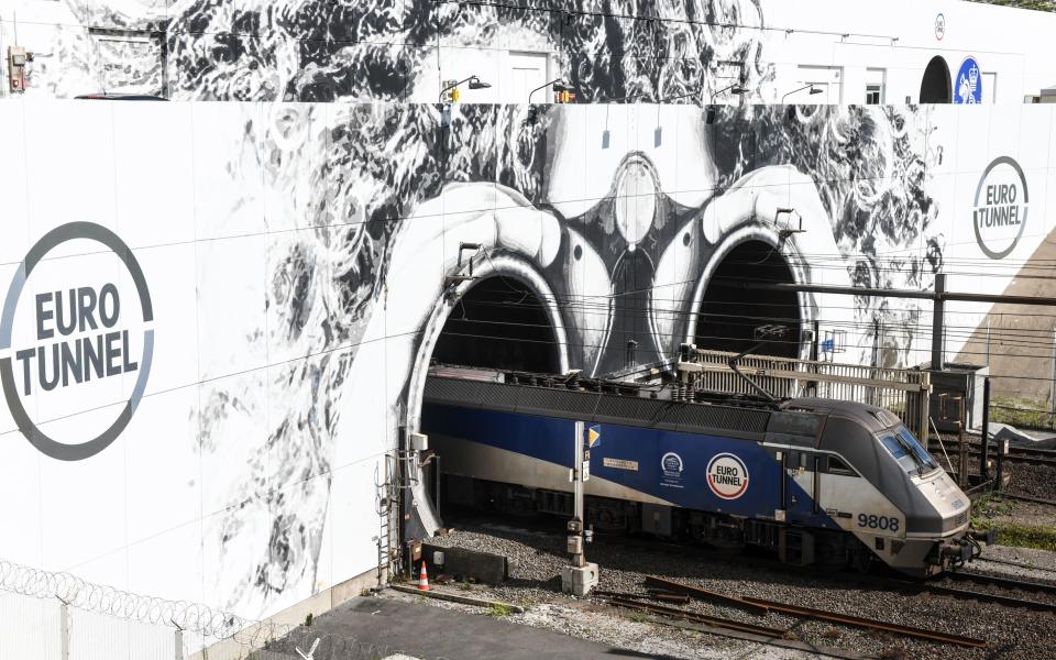 A shuttle train transporting trucks exits the Channel Tunnel, operated by EuroTunnel, in Coquelles, northern France, on July 4, 2019, on which a fresco by French-British artist YZ has been made to celebrate the 25th anniversary of Eurotunnel. (Photo by DENIS CHARLET / AFP) / RESTRICTED TO EDITORIAL USE - MANDATORY MENTION OF THE ARTIST UPON PUBLICATION - TO ILLUSTRATE THE EVENT AS SPECIFIED IN THE CAPTION        (Photo credit should read DENIS CHARLET/AFP via Getty Images)