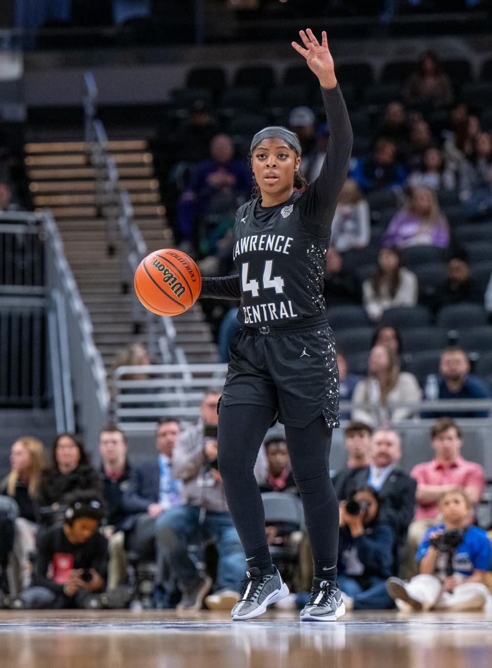 Lawrence Central High School junior Laila Abdurraqib (44) brings the ball up court while gesturing to her teammates during the second half of an IHSAA class 4A girls’ basketball state finals game against Lake Central high School, Saturday, Feb. 24, 2024, at Gainbridge Fieldhouse, in Indianapolis. Lawrence Central won the school’s first state championship title in girl’s basketball.