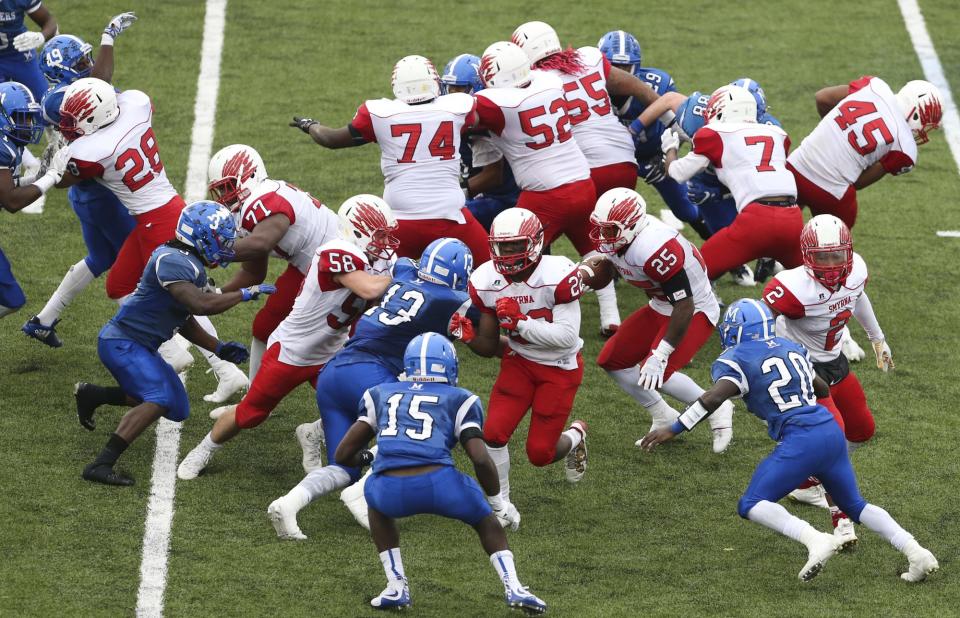 Smyrna's Will Knight (25) works a run in the 'Earthquake' formation in the fourth quarter of Smyrna's 30-27 win in the DIAA Division I state title game at Delaware Stadium in 2017.