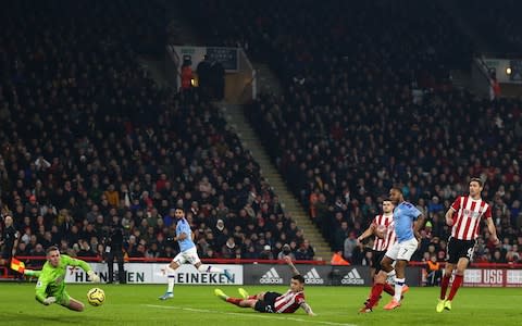  Dean Henderson of Sheffield United denies Raheem Sterling of Manchester City during the Premier League match between Sheffield United and Manchester City at Bramall Lan - Credit: Robbie Jay Barratt - AMA/Getty Images