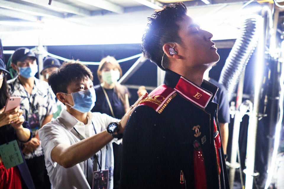 Chou receives finishing touches from his manager Reese Hsu before going onstage<span class="copyright">An Rong Xu for TIME</span>