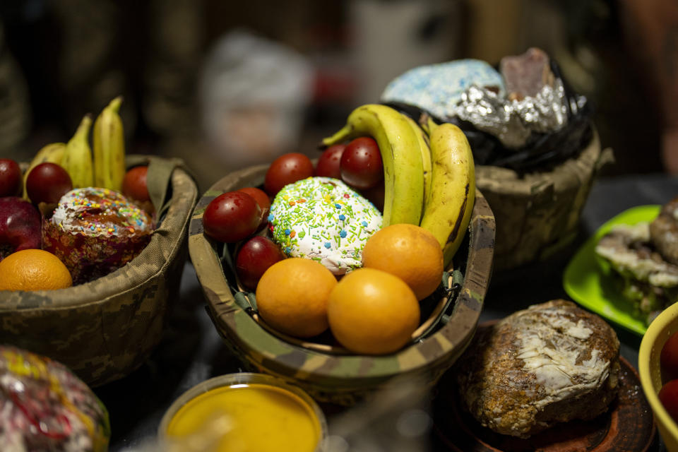 Food are gathered to be blessed during a Christian Orthodox Easter religious service at the 72nd Separate Mechanized Brigade compound, in Dnipropetrovsk region, Ukraine, early Sunday, May 5, 2024. (AP Photo/Francisco Seco)