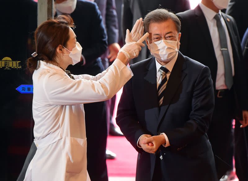 South Korean President Moon Jae-in gets temperature tested upon his arrival at the National Assembly in Seoul
