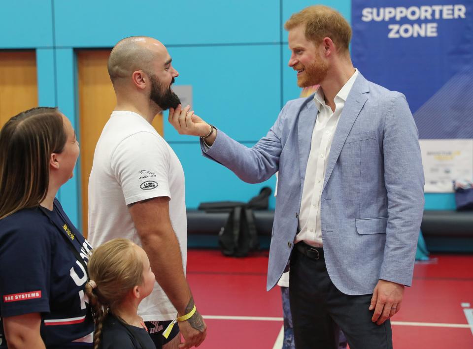 In his final stop of the day, Prince Harry headed to the Invictus UK Trials, where athletes will compete for a spot on Team UK at the <a href="https://people.com/royals/prince-harry-leaves-baby-archie-meghan-markle-trip-netherlands/" rel="nofollow noopener" target="_blank" data-ylk="slk:2020 Invictus Games at The Hague in the Netherlands;elm:context_link;itc:0;sec:content-canvas" class="link ">2020 Invictus Games at The Hague in the Netherlands</a>. The prince gave one of the athlete's beards a tug in a candid moment.