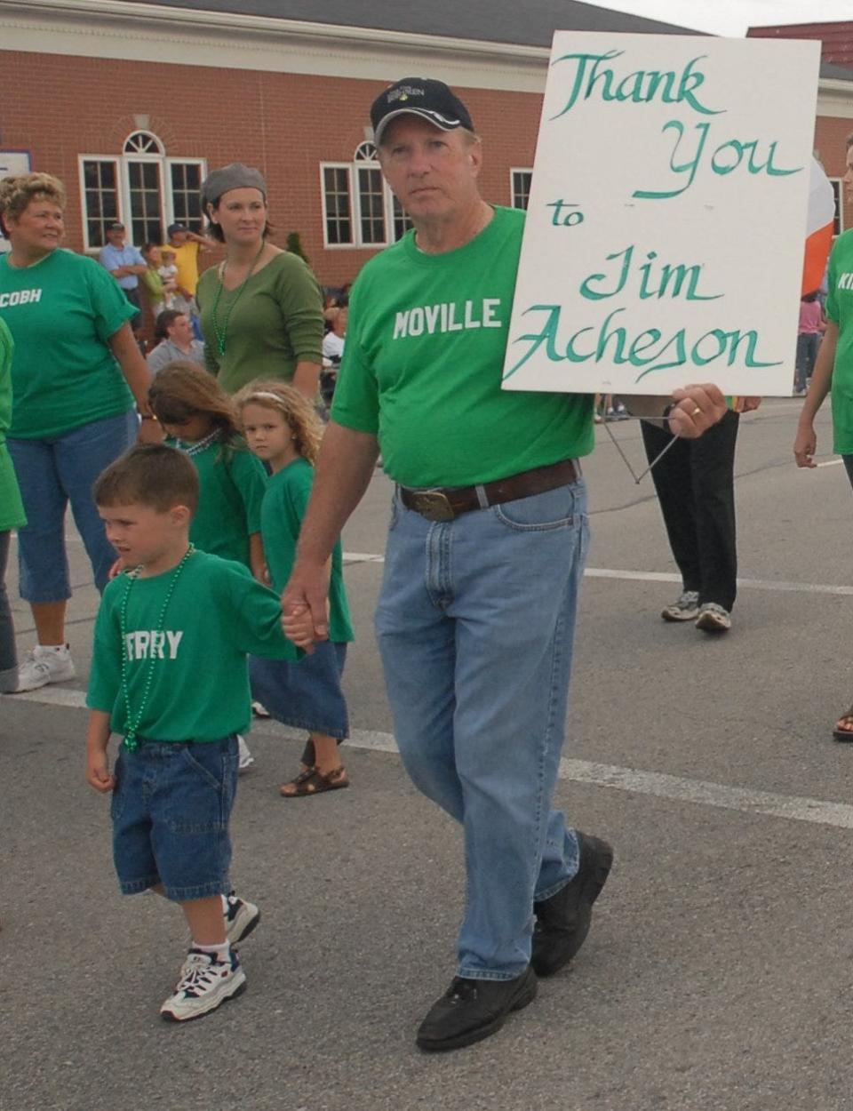 At a parade in the early 2000s, Jim Haley and his grandson, Brendan Connelly, then age 4, let Jim Acheson, who was a parade grand marshal, know what they think of him.