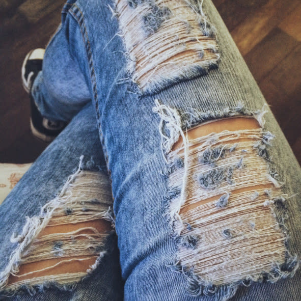 a person's ripped jeans