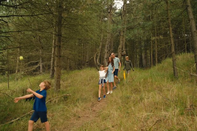 <p>The Prince and Princess of Wales/Youtube</p> Prince Louis throwing a ball as Princess Charlotte, Catherine, Princess of Wales, Prince William and Prince George follow him in a Sept. 9, 2024 video message