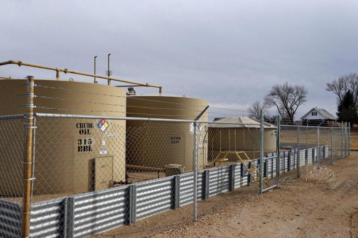 This Feb. 13, 2017 file photo shows a crude oil storage tank behind a fence near Mead, Colo.  (Photo: Brennan Linsley/AP)