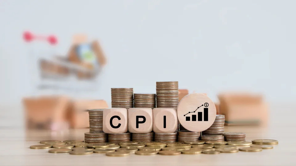 CPI, consumer price index concept. Wooden block with the words CPI on coins stack. Goods price inflation and inflation rising. Impact on economic growth with relate icon.