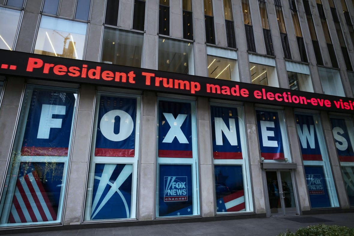 FILE – A headline about President Donald Trump is displayed outside Fox News studios in New York on Nov. 28, 2018. Documents in defamation lawsuit illustrate pressures faced by Fox News journalists in the weeks after the 2020 presidential election. The network was on a collision course between giving its conservative audience what it wanted and reporting uncomfortable truths about then-President Donald Trump and his false fraud claims. (AP Photo/Mark Lennihan, File)