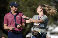 Haley Ortiz, left, runs onto the 18th green to greet her husband, Carlos Ortiz, after Carlos won the Houston Open golf tournament, Sunday, Nov. 8, 2020, in Houston. (AP Photo/Eric Christian Smith)