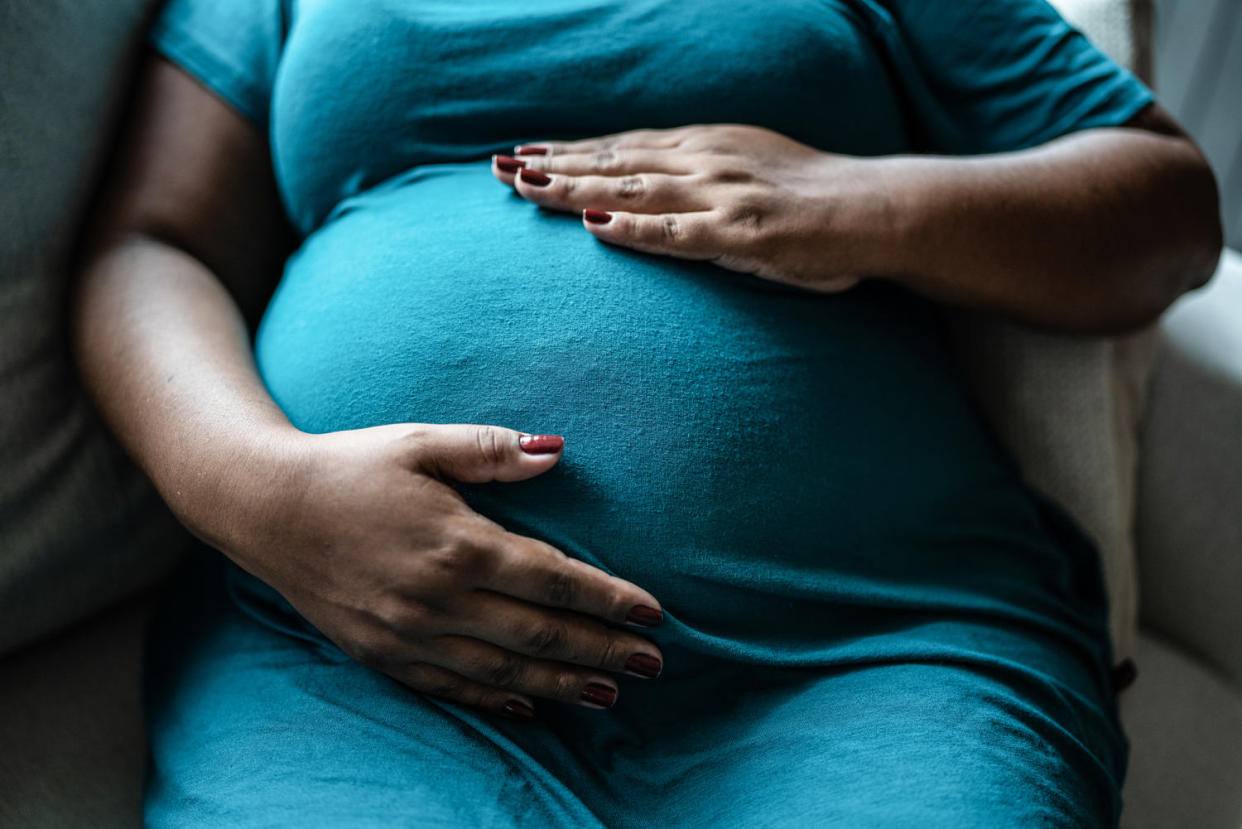 Pregnant woman touching her belly (FG Trade / Getty Images)