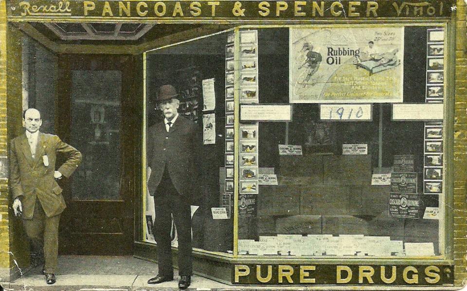 Duff Pancoast, left, stands in front of the Pancoast and Spencer store with a salesman. The drug store was located at 46 W. Main St.