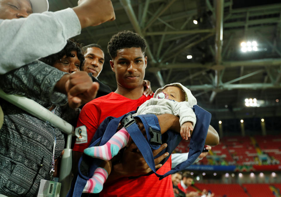 <p>England’s Marcus Rashford with a child after the match. REUTERS/John Sibley </p>