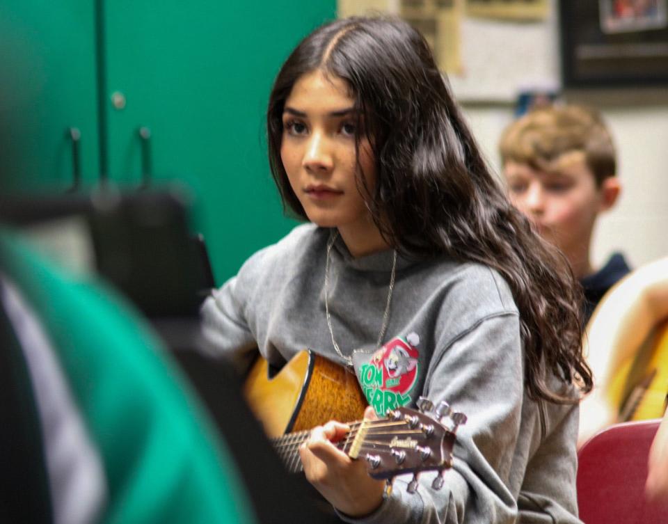 Eighth grader Valeria Silvestre plays alongside Daniel Neihoff during advanced guitar class.