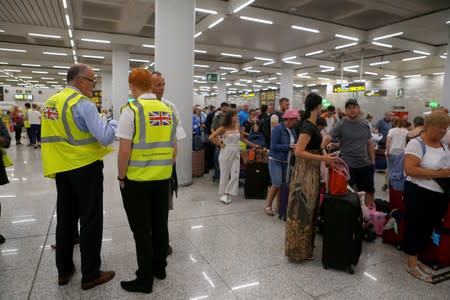 British government officials are seen at Thomas Cook check-in points at Mallorca Airport after the world's oldest travel firm collapsed, in Palma de Mallorca