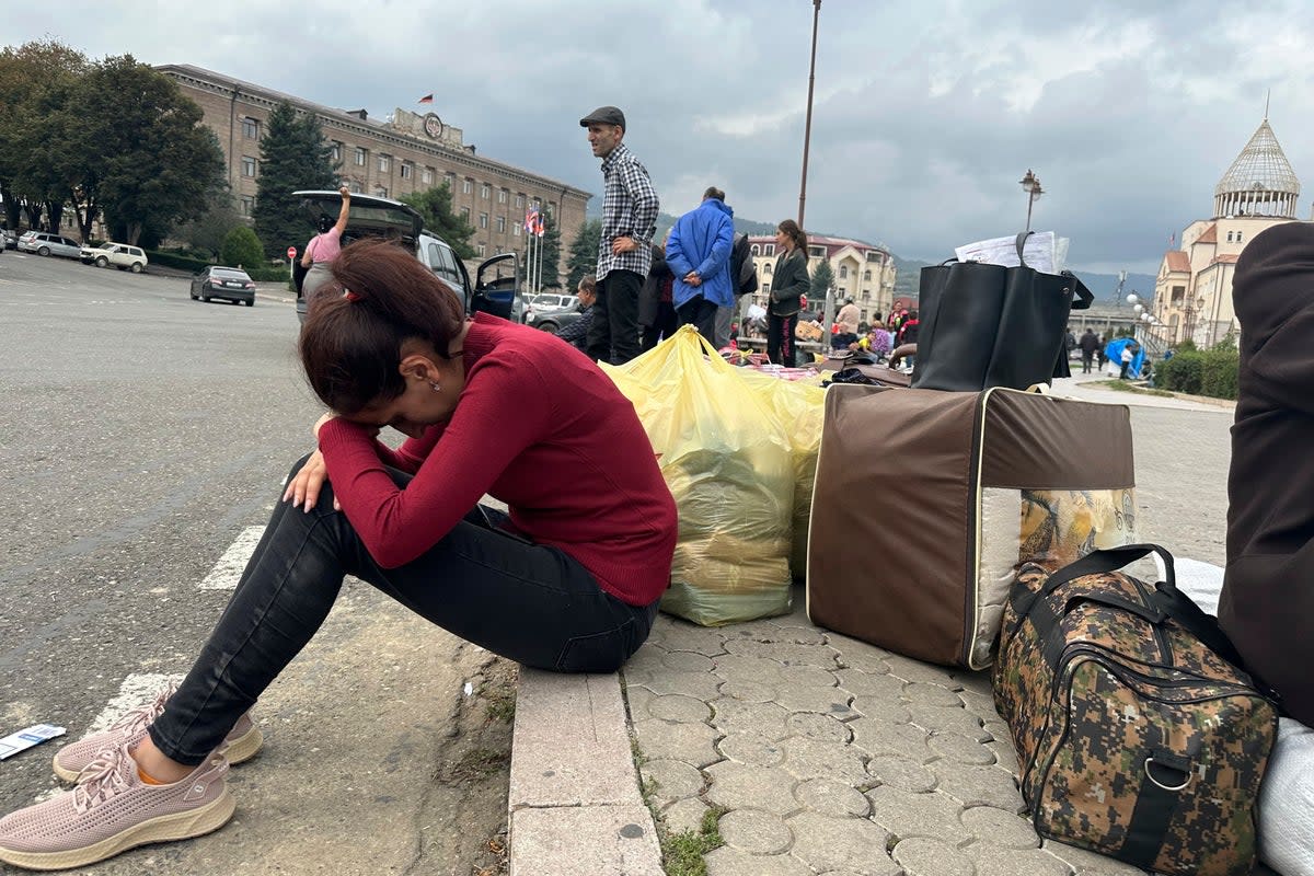 Ethnic Armenians gather in hope to leave Nagorno-Karabakh region for Armenia in the center of Stepanakert  (AP)