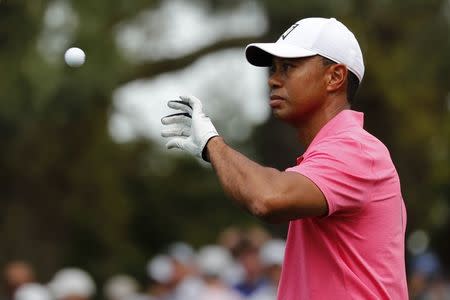 Tiger Woods of the U.S. catches a ball from his caddie on the first hole during practice for the 2018 Masters golf tournament at Augusta National Golf Club in Augusta, Georgia, U.S. April 2, 2018. REUTERS/Jonathan Ernst